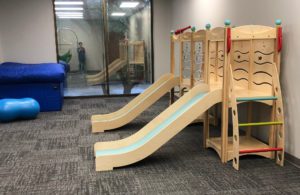 an open play room with a ball pit and two slides