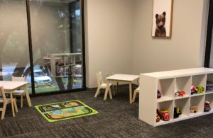 a neatly organized play area with tables and chairs